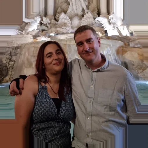 Sonay and James hugging in front of the Trevi Fountain in Rome, Italy
