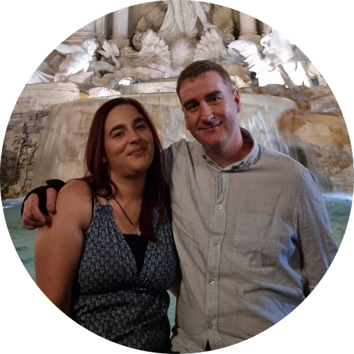 Sonay and James hugging in front of the Trevi fountain in Rome, Italy