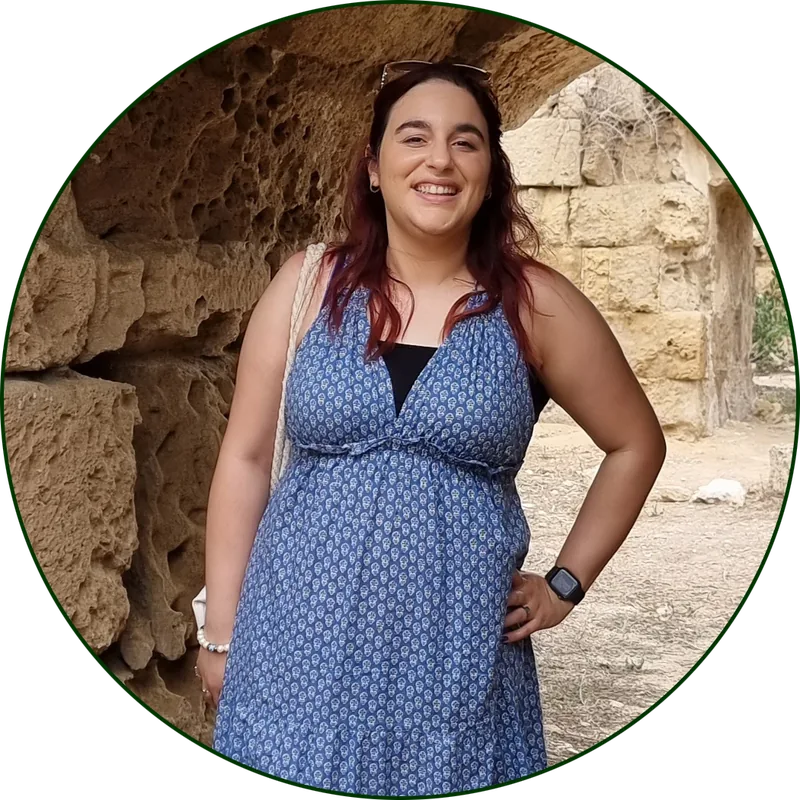 Sonay wearing a blue dress and smiling.