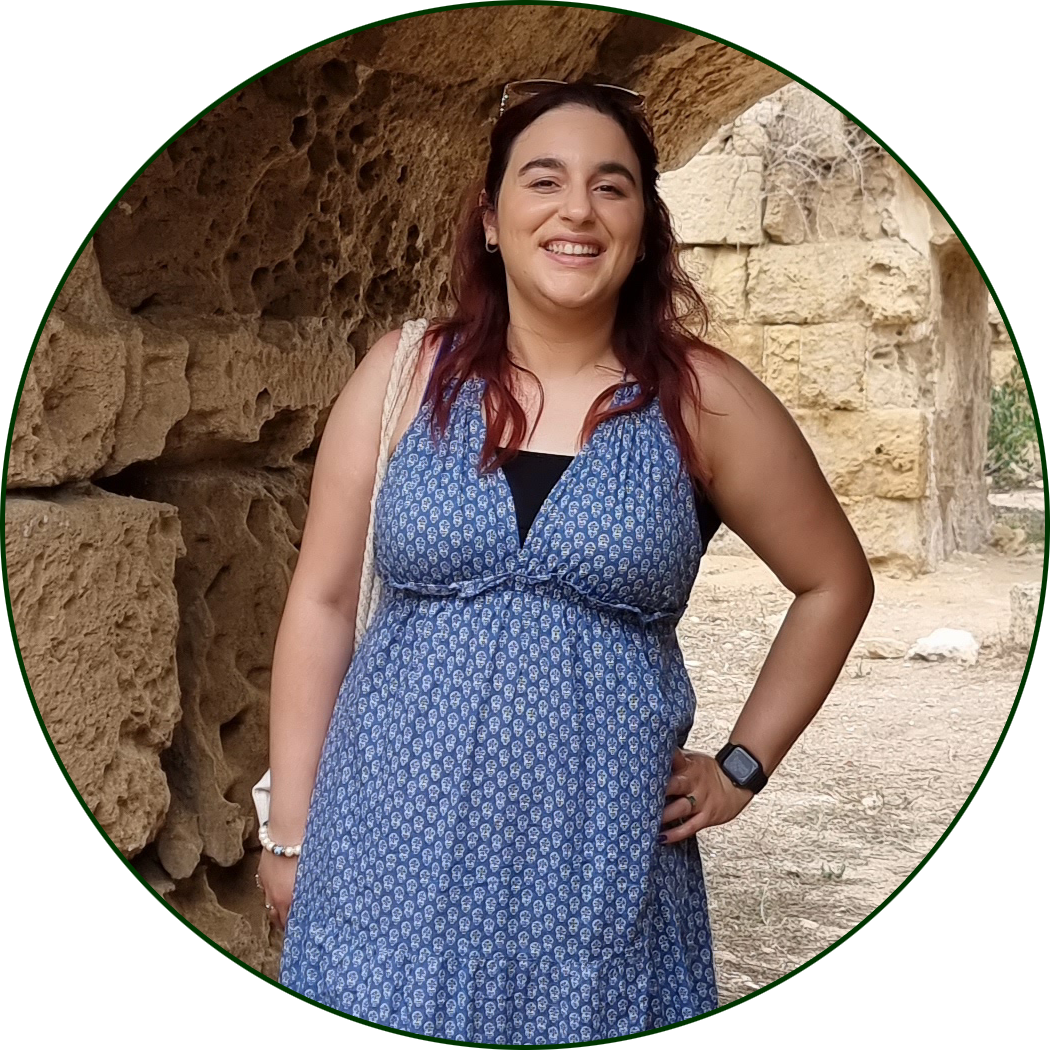 Sonay wearing a blue dress, and smiling.