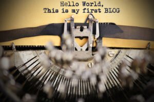 Vintage typewriter with the words Hello World, this is my first blog