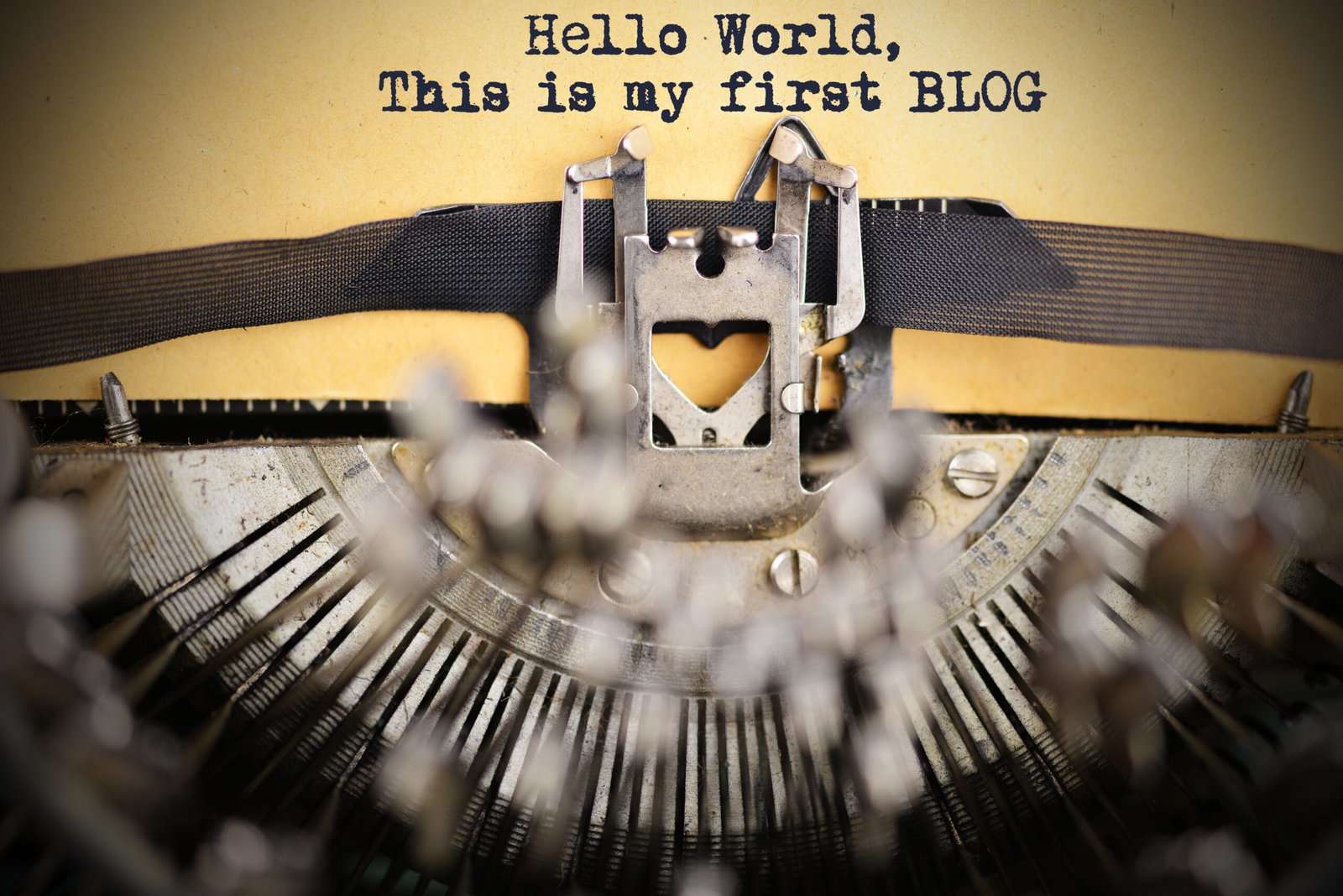 Vintage typewriter with the words Hello World, this is my first blog