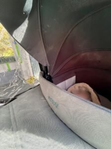 Baby sleeping in a pram with the hood pulled up
